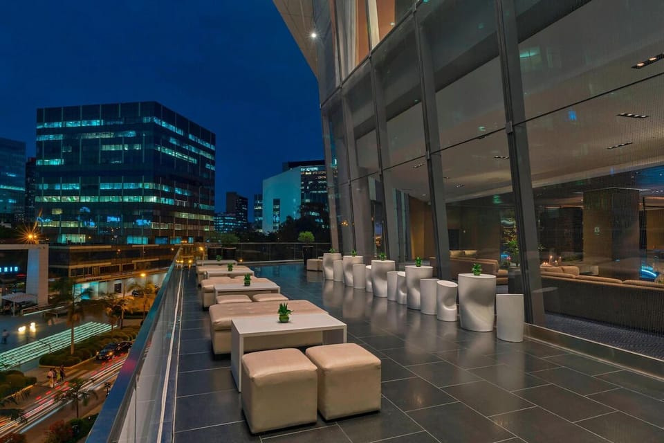 Lounge above the city as lights sparkle at twilight.
