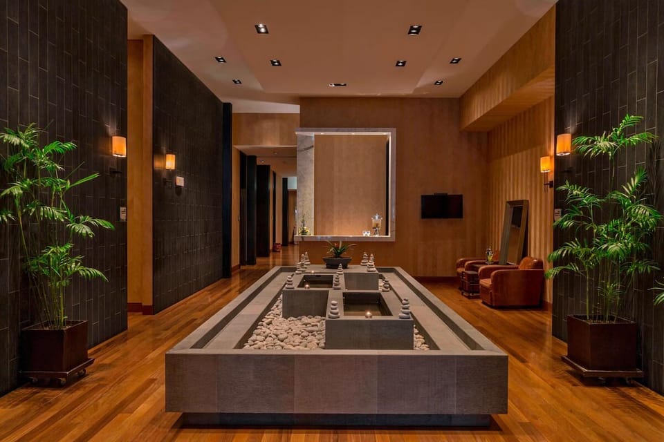 Unwind beside tranquil water features in a serene spa corridor.