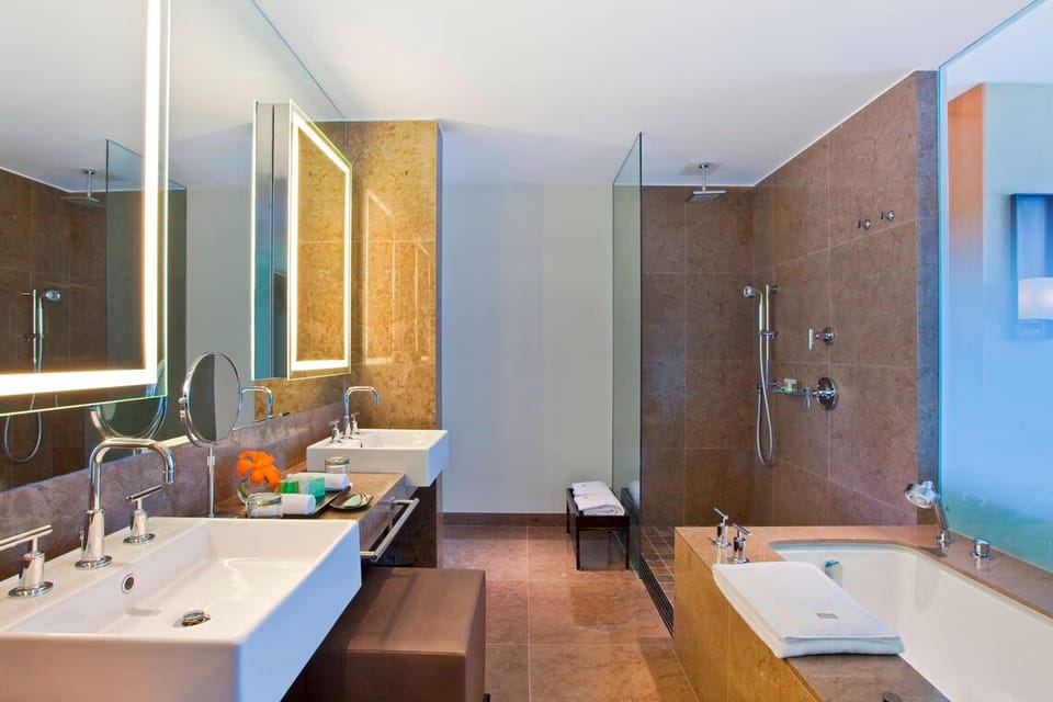 Indulge in a long soak beside glowing mirrors and stone finishes.
