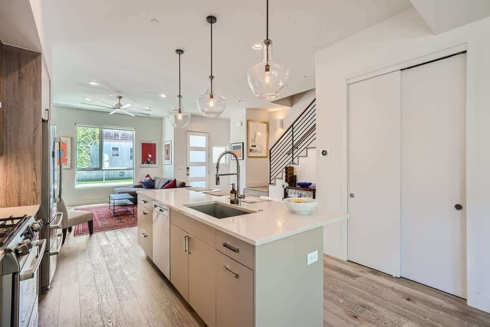 Sleek Kitchen showing stairs that lead upstairs 