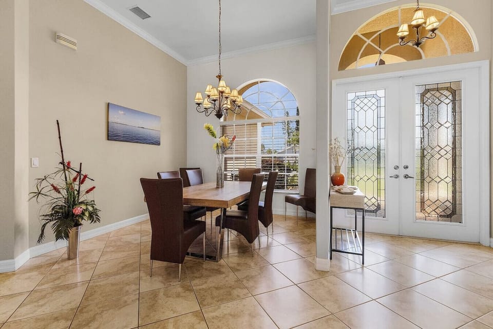 Welcoming foyer with elegant glass doors and natural light.