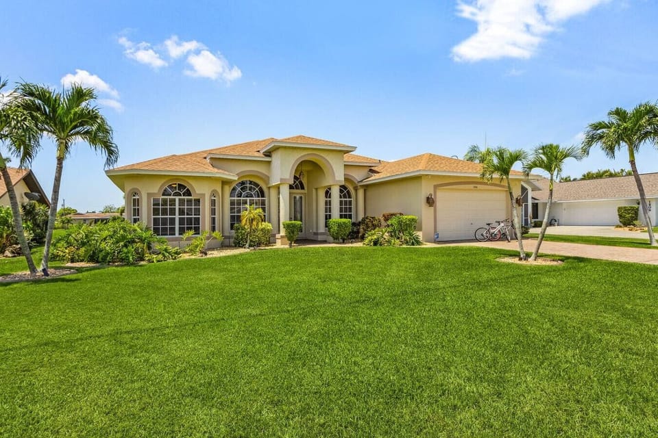 Charming villa with lush garden and spacious driveway, perfect for a relaxing getaway.