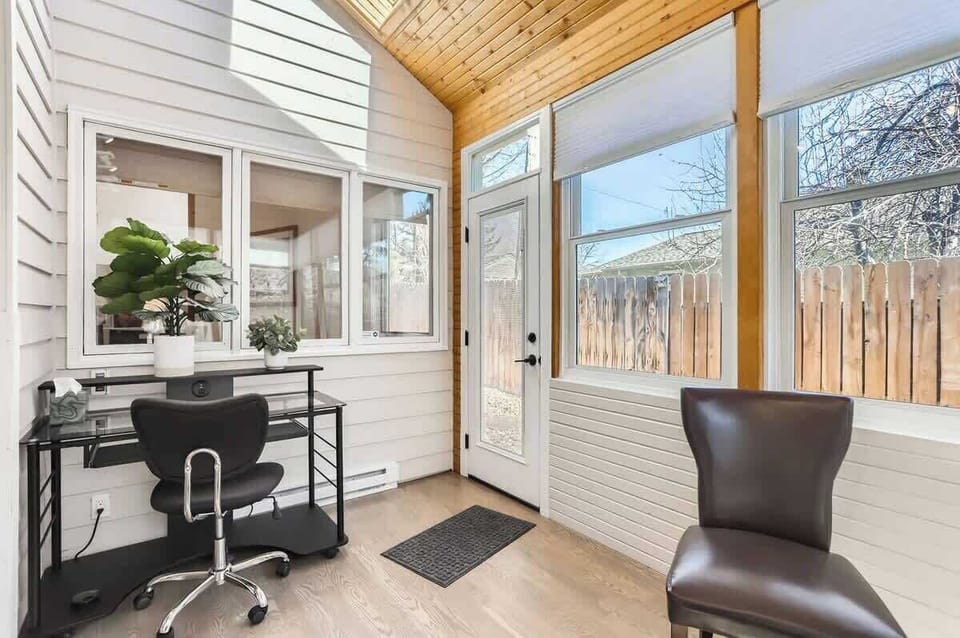 Bright office/sunroom with ample natural light, ideal for work, reading, or relaxing