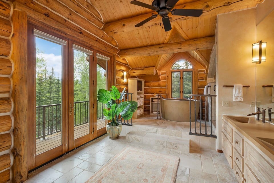 This stunning Primary Bathroom features a large steam walk-in shower, private deck and stone soaking tub.