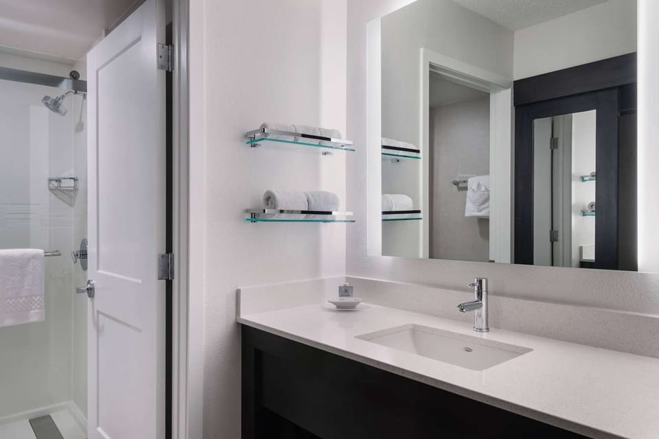 Refresh in a spotless bath with bright vanity and shower.