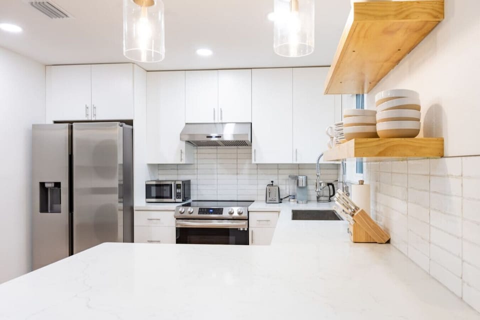 Beautifully designed kitchen with ample counter space, stainless steel appliances, and elegant lighting.