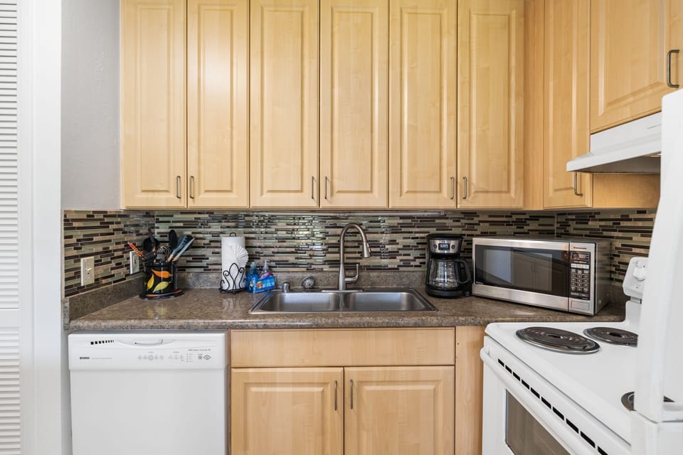  Wrapped in golden maple and soft morning light, this kitchen invites you to slow-cook, sip, and savor every island moment    KUL-E117