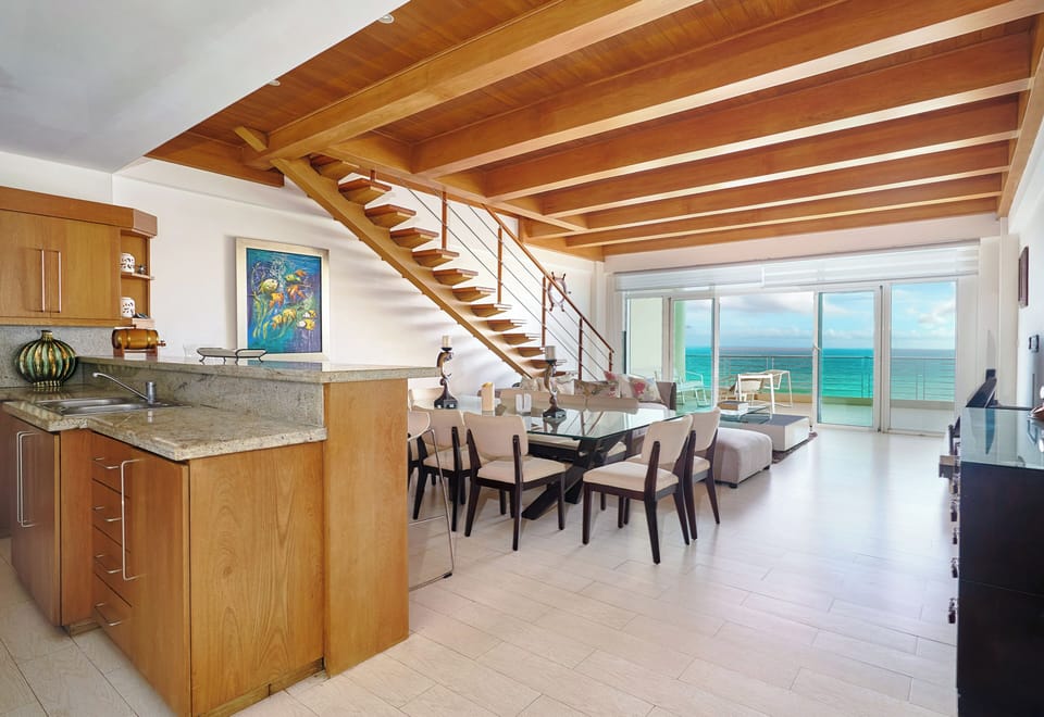 Spacious open-concept living, dining, and kitchen area with stunning ocean views — perfect for family gatherings and entertaining.