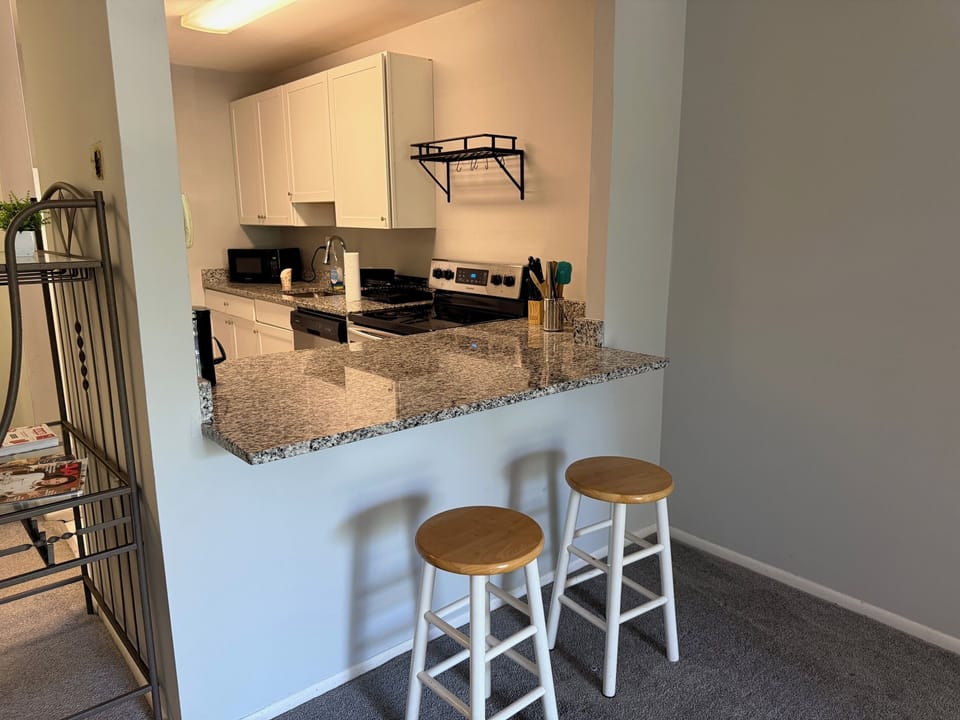 Step into a well-appointed kitchen designed for convenience. It includes a full-sized refrigerator, range, and plenty of counter space for meal prep. You'll find generous storage in the cabinetry, making it easy to keep things organized.
