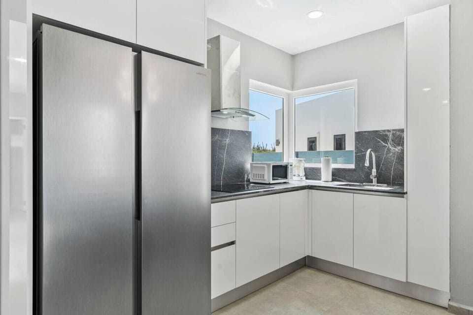 Fully equipped kitchen with stainless steel appliances.