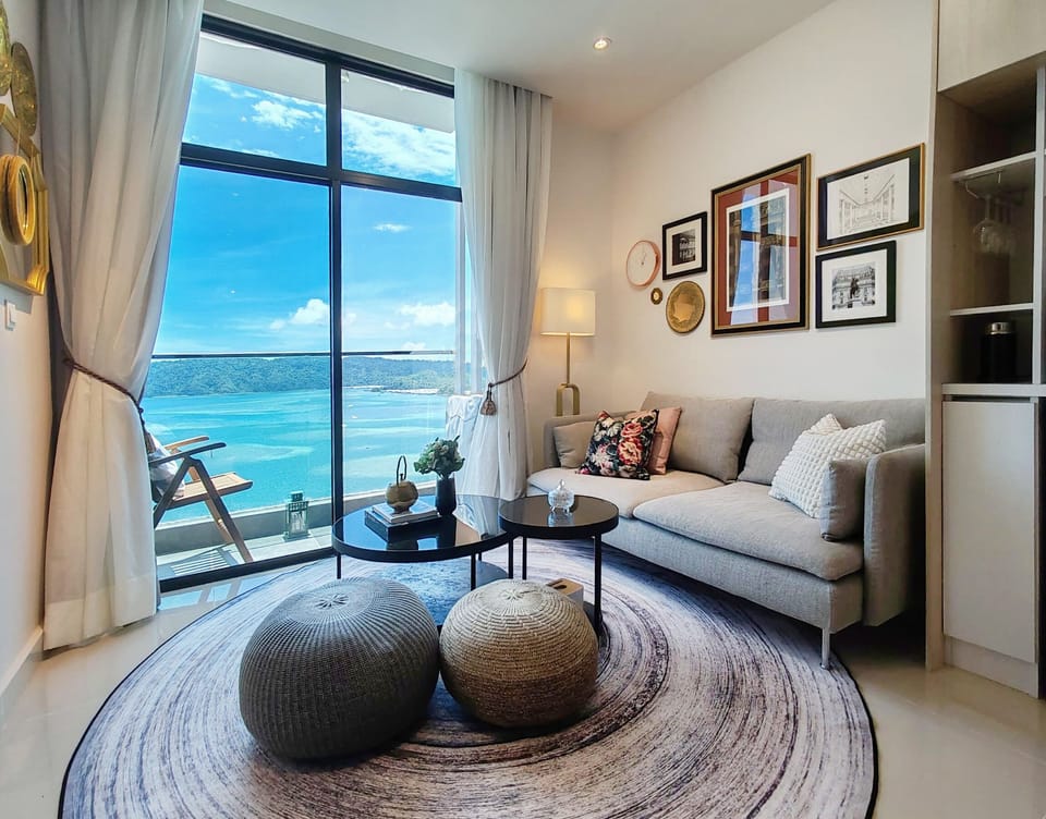 Sunlit living room with sea views and curated art — a calm retreat by the coast.