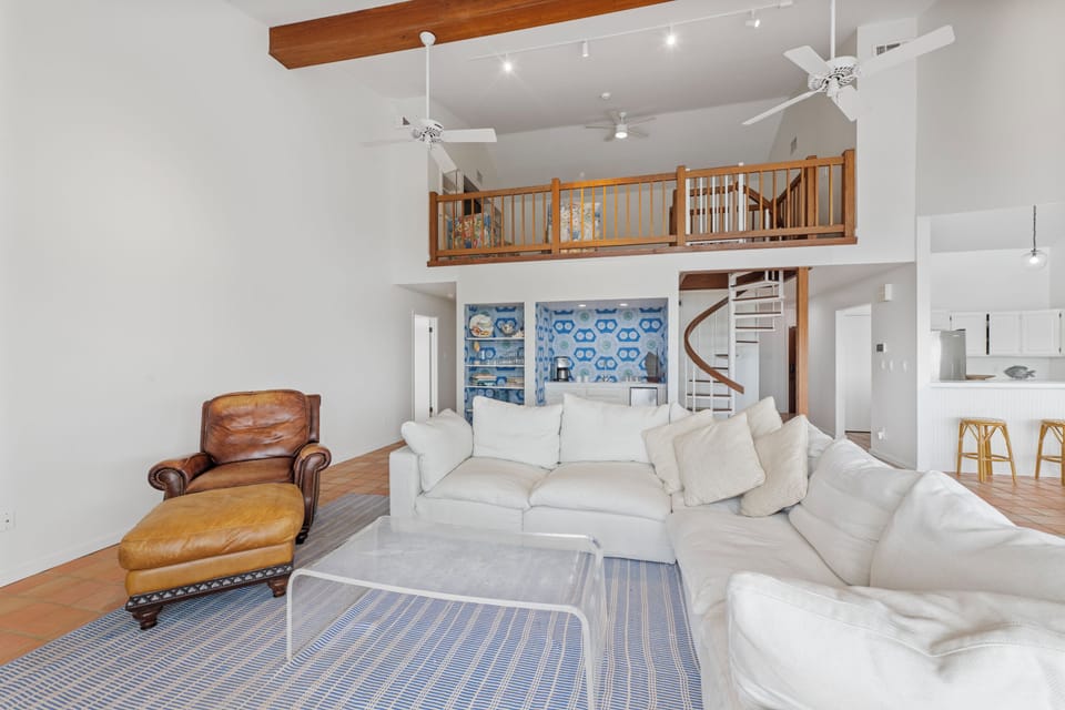 Unwind in your spacious loft with soaring ceilings, cozy leather seating, and a stunning spiral staircase leading to your private upstairs retreat.