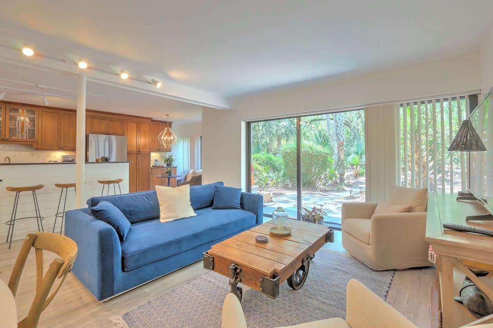 Bright living area with ample seating and TV