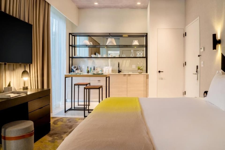 Settle in with a cozy bed beside a handy kitchenette.
