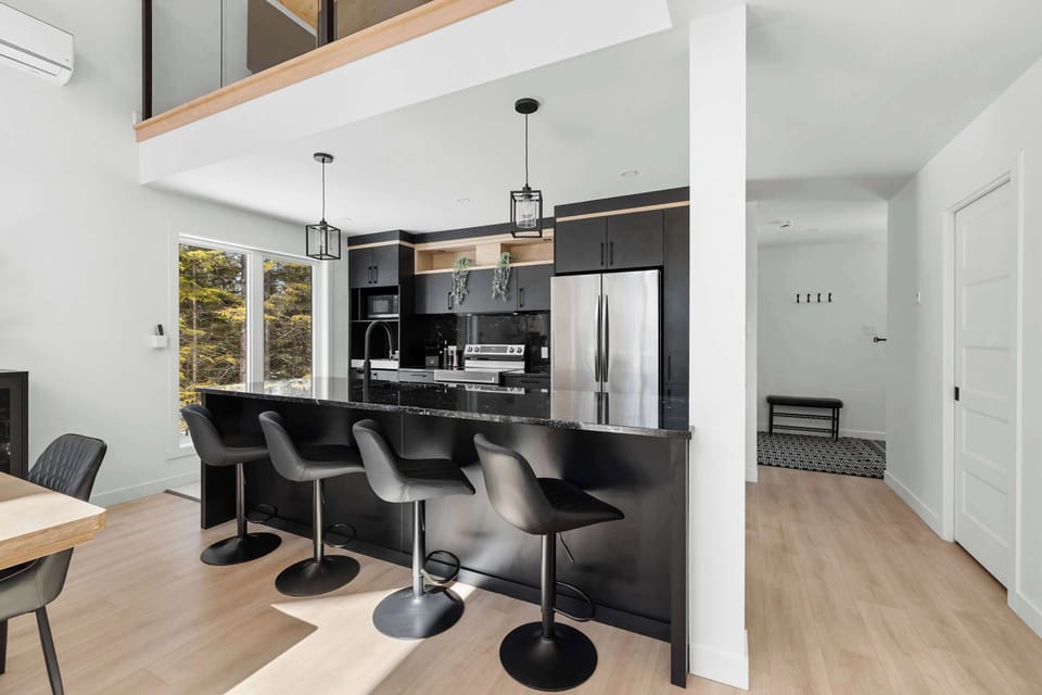 Cuisine et salle à manger : Élégance moderne avec coin-bar raffiné et grandes fenêtres offrant une vue splendide sur la nature !