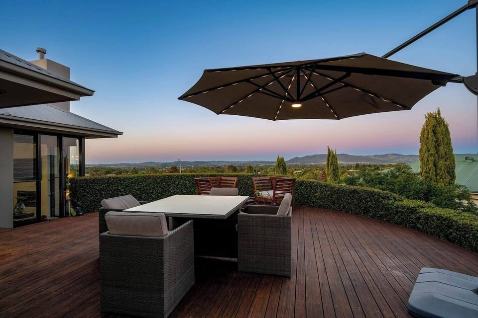 The open-air deck invites alfresco meals with stunning views. An umbrella provides shade in the summer months.

