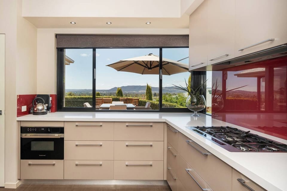 Whip up shared feasts or morning rituals in this fully equipped kitchen, framed by stunning valley views.

