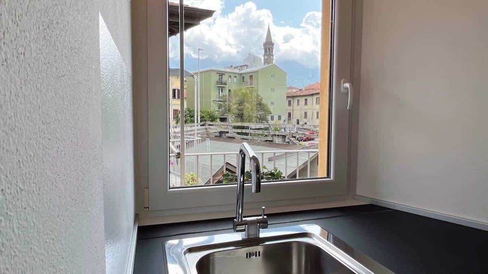 kitchen provided with window with sight on the famous Lecco bell-tower