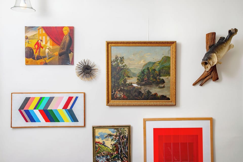 Resting place at the top of the stairs with the chicest art collection for your viewing pleasure.