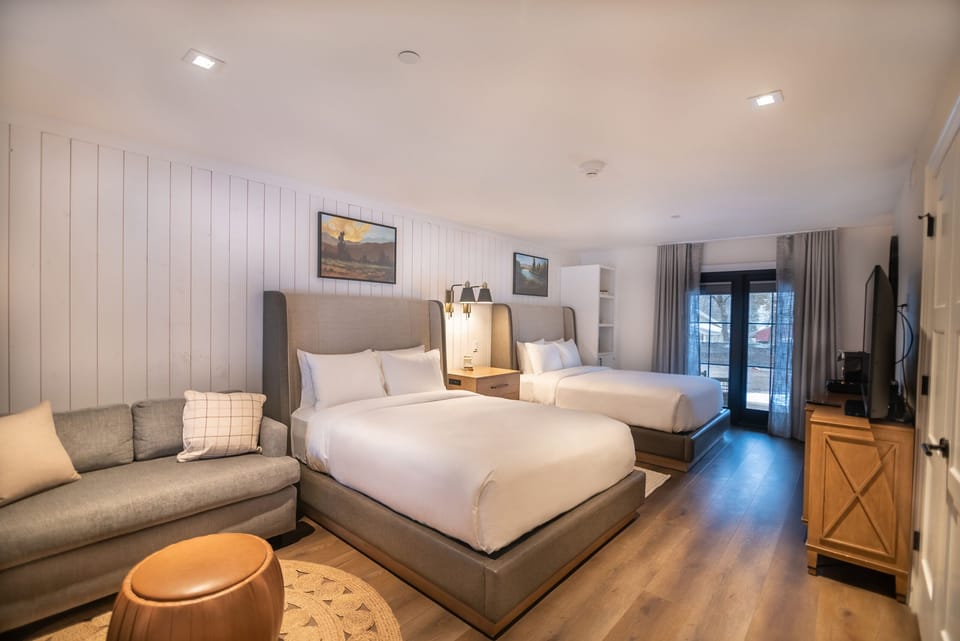 Unwind in a bright double-queen room with lounge seating.