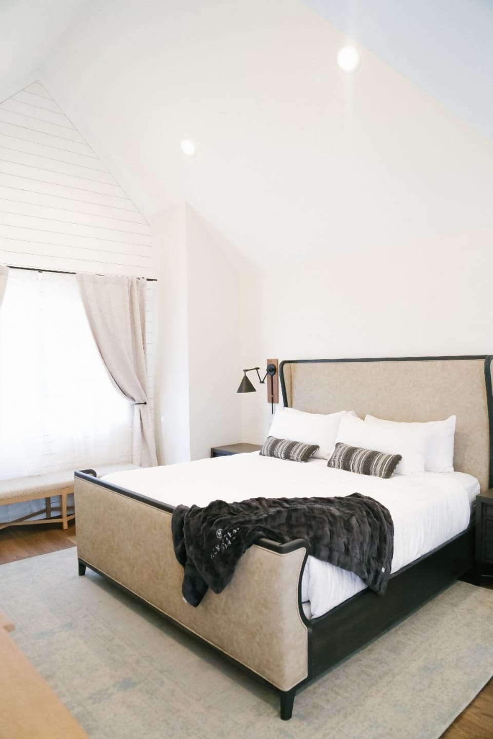 Sink into crisp linens beneath airy, sunlit vaulted ceilings.