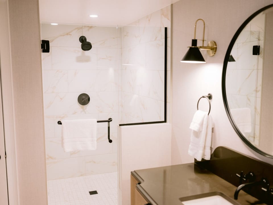 Rinse off in a modern marble shower with luxe fixtures.
