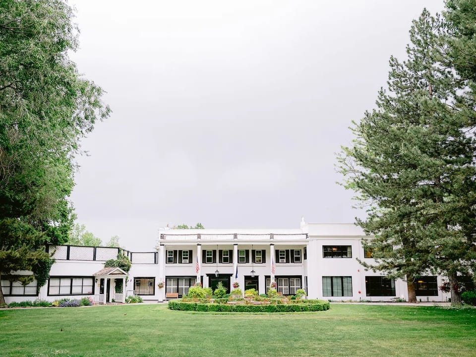 Arrive to a grand estate framed by lush lawns.