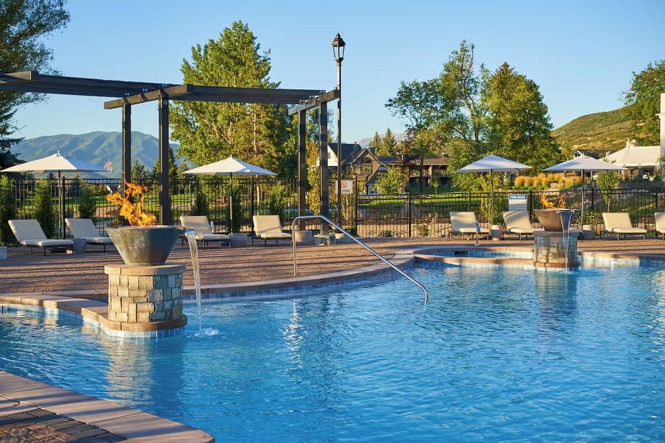 Dive into sparkling resort pools with mountain-view serenity.