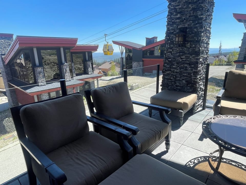 The main floor balcony has a comfortable outdoor seating area for quiet talks