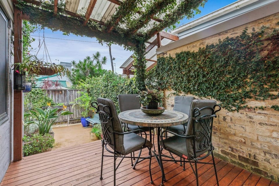 Step outside to the leafy patio, perfect for sipping morning coffee or enjoying relaxed dinners in the fresh air.