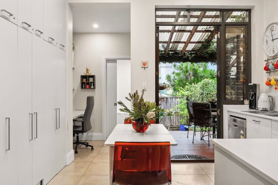 A clever layout leads from dining to a quiet workspace and out to the inviting garden, where comfort and practicality blend effortlessly.