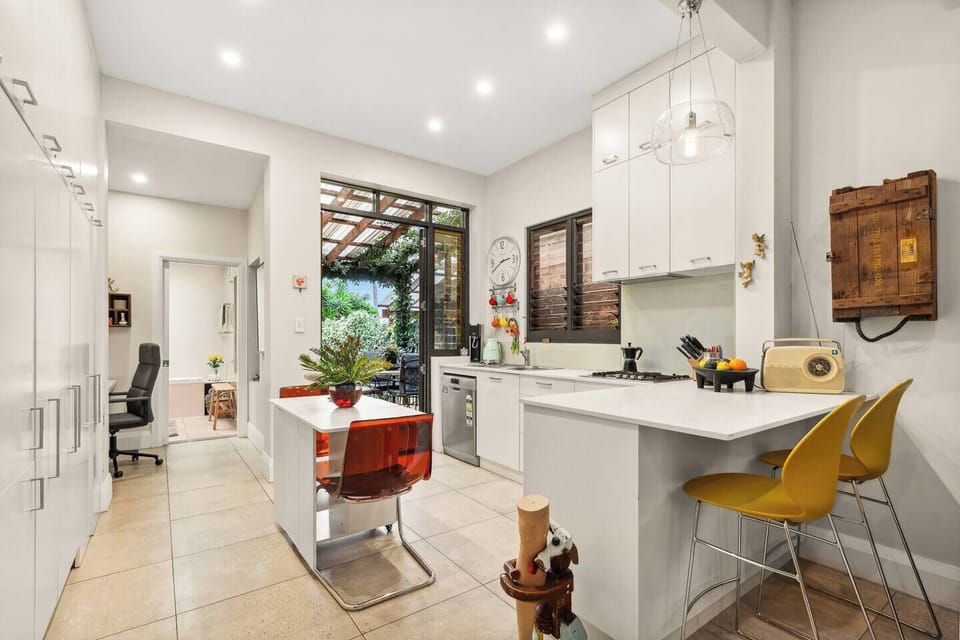 Share meals at the intimate dining table or perch at the breakfast bar, all just steps from the leafy garden for a breezy, connected living experience.
