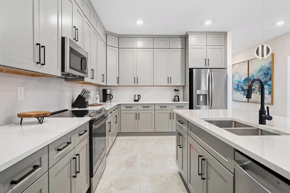 Prep fresh meals on expansive counters with sleek modern cabinetry.