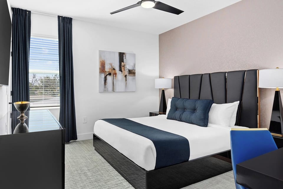 Unwind in a sleek king retreat with calming light.