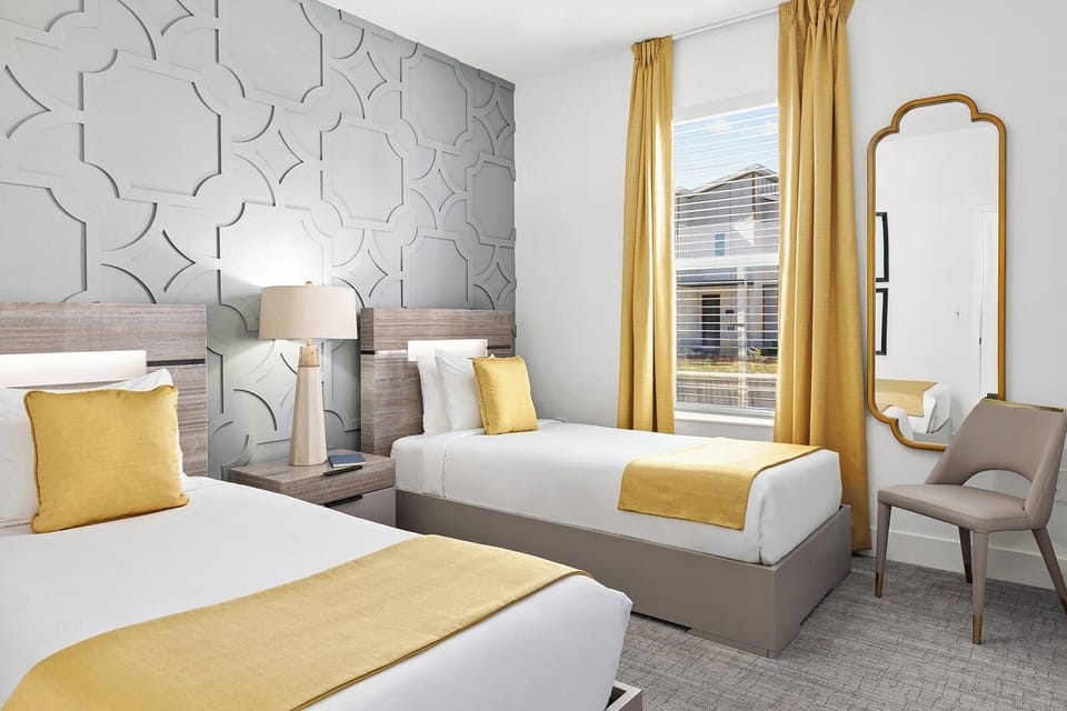 Recharge together in a bright twin room with warm accents.