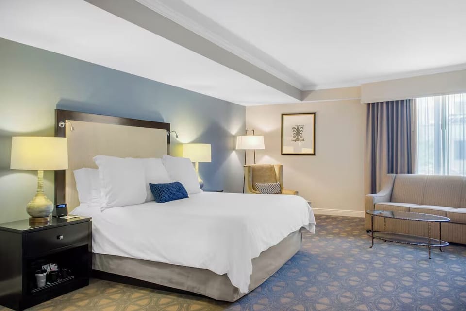 Unwind in a spacious king room with cozy lounge seating.