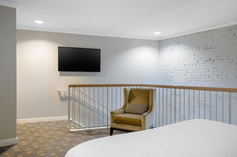 Lounge upstairs with cozy seating and a wall-mounted TV.