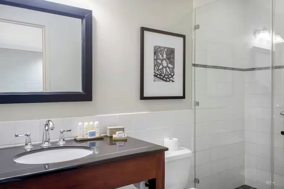 Freshen up with premium toiletries beside a sleek vanity mirror.