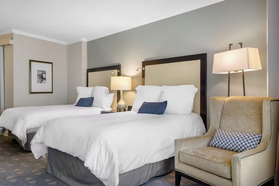 Sink into serenity with cozy chair and cloud-like beds.