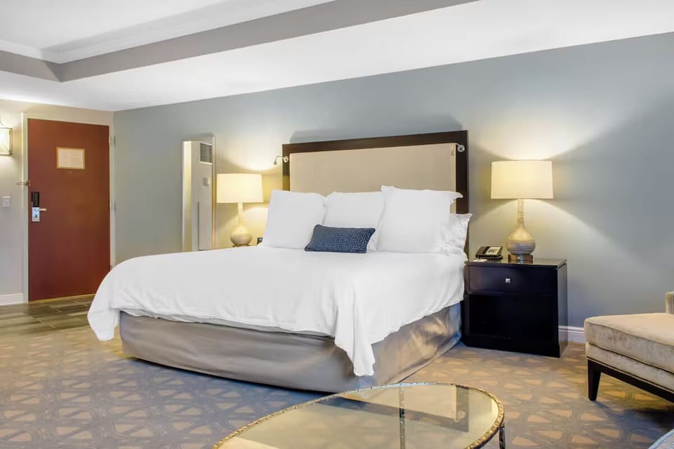 Relax under warm bedside lamps in a quiet, comfortable retreat.