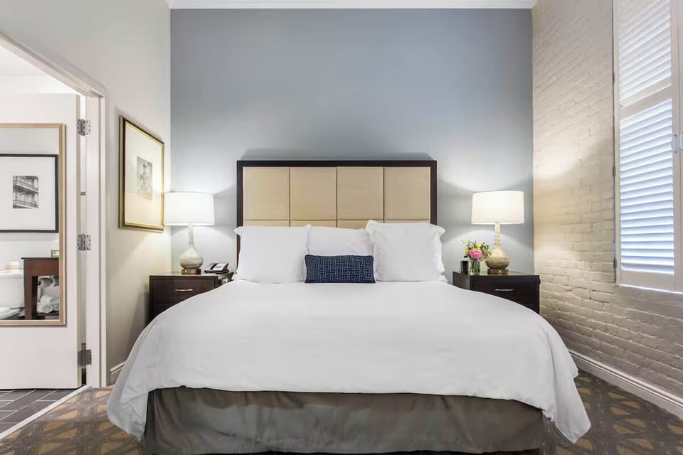 Unwind in a serene king room with soft, balanced lighting.