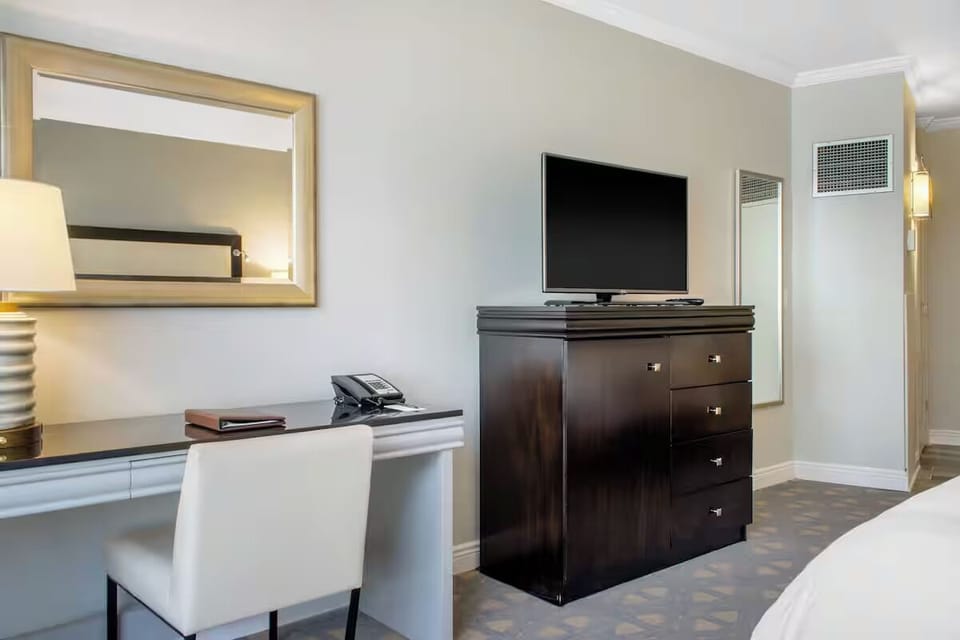 Catch up on work comfortably with desk, TV, and calm space.