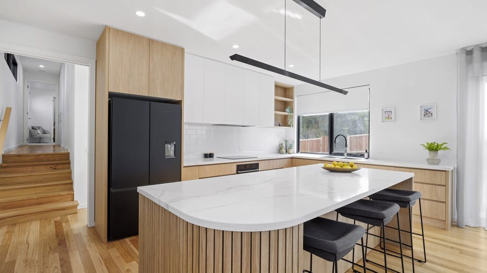 Beautiful open-plan kitchen with timber island bench, induction cooktop, butler’s pantry, and everything you need for easy holiday cooking.