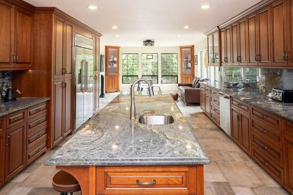 The kitchen center island is 9.5 feet long! It makes group cooking super fun.