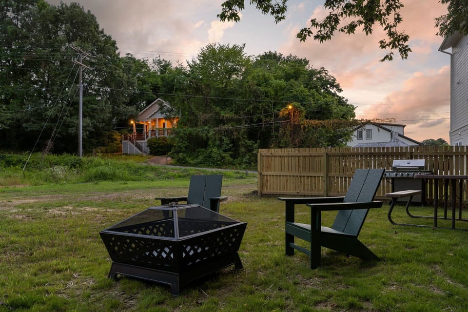 Beautiful outdoor space with a grill, firepit, hangout area & string lights