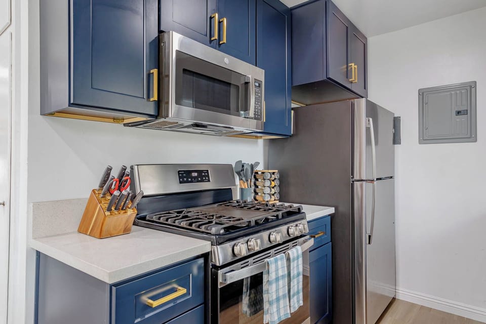 Fully stocked kitchen includes refrigerator, microwave, stove and oven. 