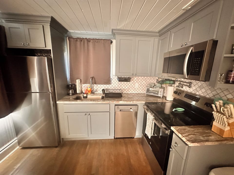 full kitchen with dishwasher, fridge, range/oven, pot filler, microwave, 