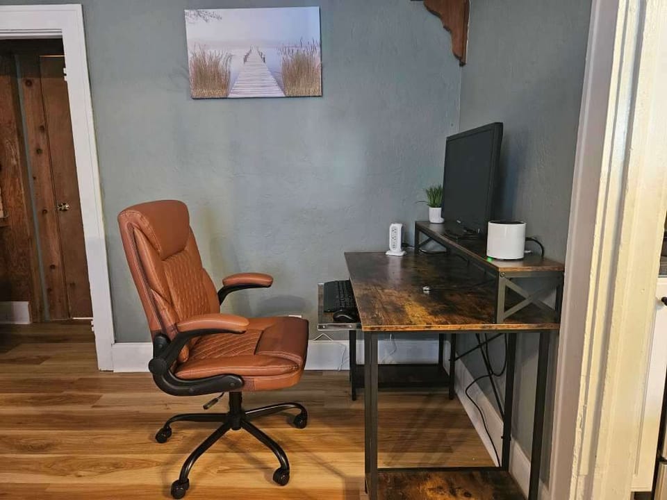 Dedicated workspace with adjustable chair, monitor, wireless keyboard and mouse.