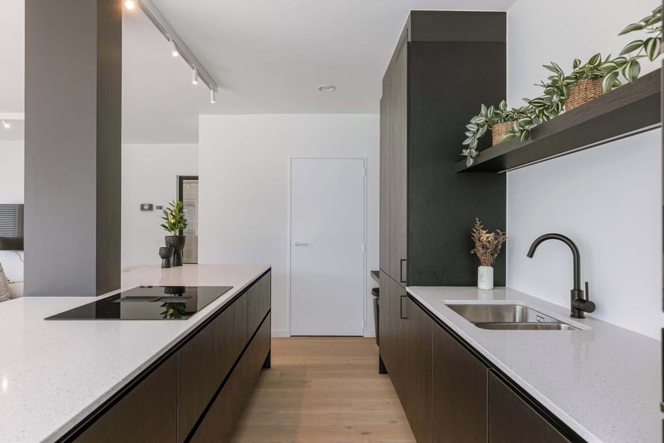 Stylish kitchen in black and oak tones — smart and sleek.
