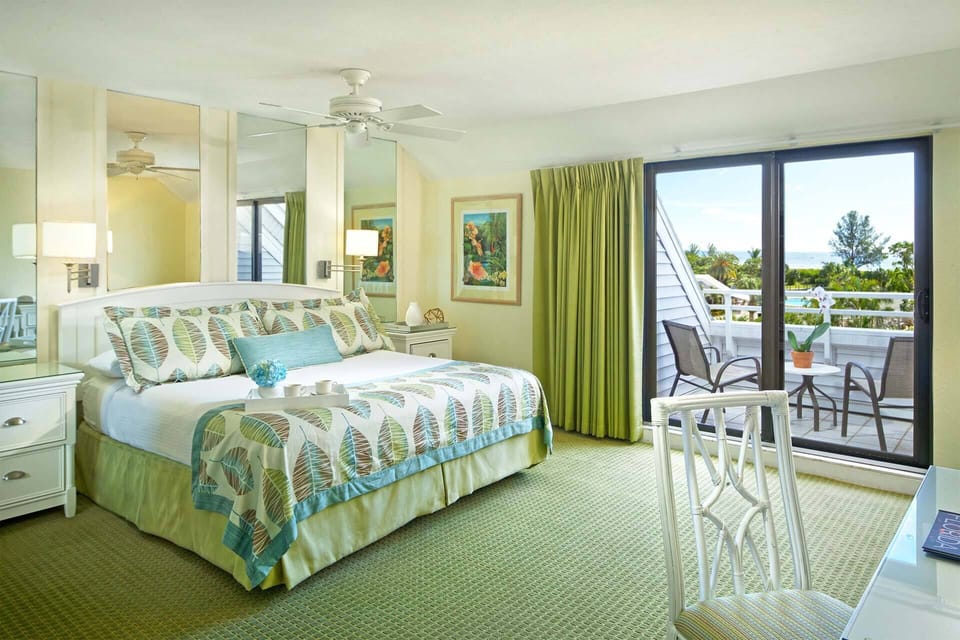 Primary Bedroom features a king bed and private balcony.